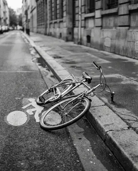 Bicycle resting on the road beside a painted bike lane
