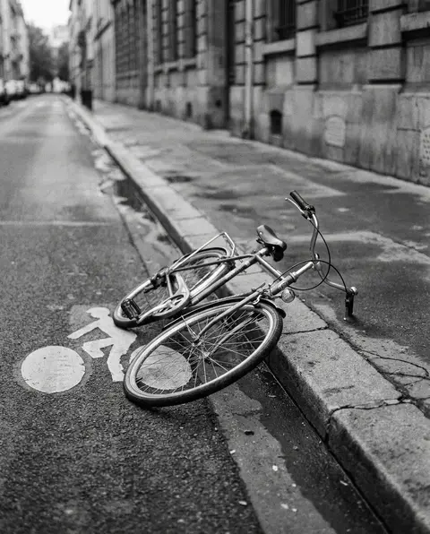 Bicycle resting on the road beside a painted bike lane