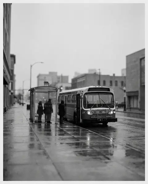 City transit bus stopped at a roadside bus stop