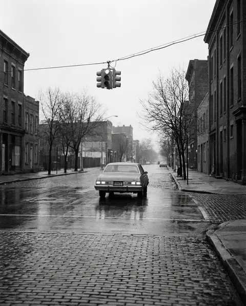 Cars stopped at a Wilmington street intersection beneath a traffic signal