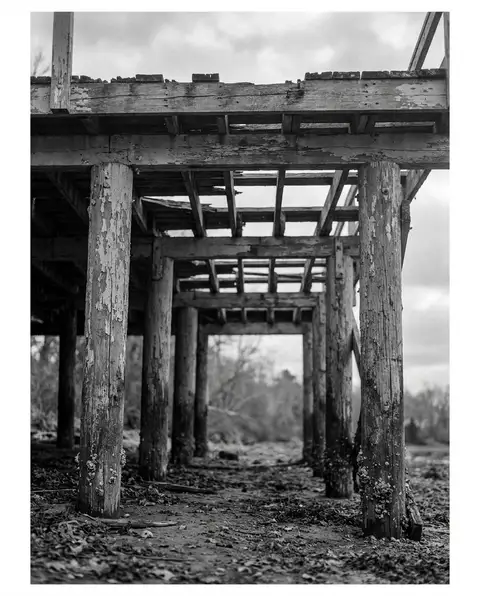 Weathered elevated wooden deck on aging support posts