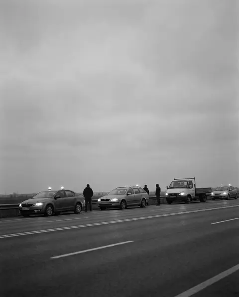 Cars stopped with hazard lights across a multi-lane highway
