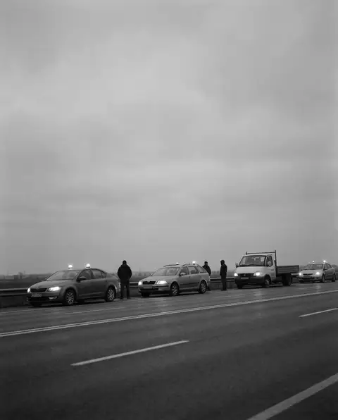 Cars stopped with hazard lights across a multi-lane highway