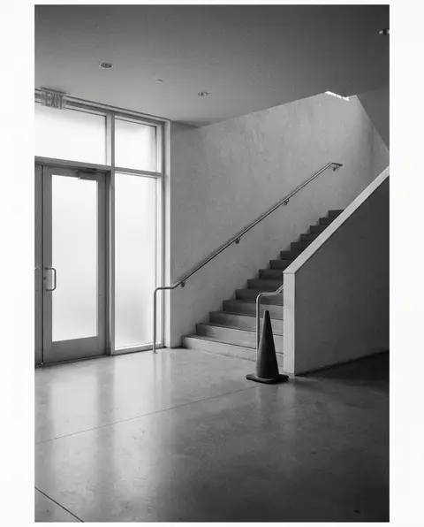Hazard cone at the base of a staircase in an empty building lobby